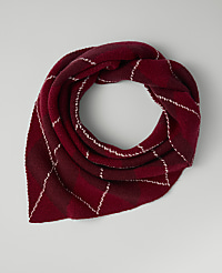A red plaid scarf is coiled on a plain light gray background. carousel Product Image 2