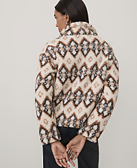 A woman wearing a patterned beige and brown fuzzy jacket stands with her back to the camera against a plain light gray background. carousel Product Image 2