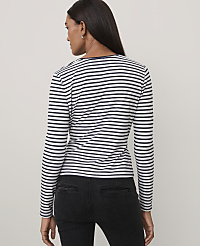 A woman wearing a black and white striped long-sleeve shirt and black jeans stands against a plain light gray background. carousel Product Image 2