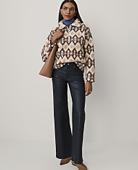 A woman wearing a patterned fuzzy pullover, dark wide-leg trousers, and brown boots stands against a plain light gray background. carousel Product Image 3