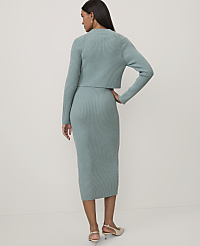 A woman stands with her back to the camera wearing a sage green ribbed knit two-piece set against a plain white background. carousel Product Image 2