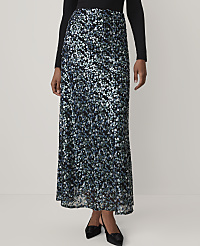 A person wears a long, shimmering blue and silver sequined skirt and a black top against a plain, light-colored background. carousel Product Image 2