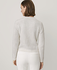 A woman wearing a white textured sweater and white pants stands against a plain light gray background. carousel Product Image 2