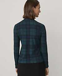 A woman wearing a green and navy blue plaid top and black pants stands against a plain light gray background. carousel Product Image 2