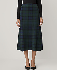 A person wears a black top and a green and blue plaid midi skirt against a plain white background. carousel Product Image 2
