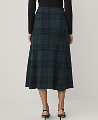 A person wearing a black top and a green plaid midi skirt stands against a plain white background. carousel Product Image 3