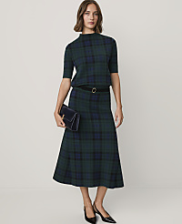 A woman wearing a green plaid two-piece set and black heels stands against a plain white background. carousel Product Image 4