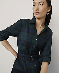 A woman wearing a dark green plaid belted dress stands against a plain, light-colored background. carousel Product Image 3