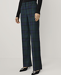 A person wearing a black sweater, green and blue plaid trousers, and black pointed heels stands against a plain white background. carousel Product Image 2