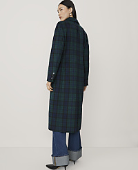 A woman wearing a long green and blue plaid coat and cuffed blue jeans stands against a plain, light-colored background. carousel Product Image 2
