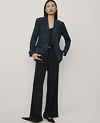 A woman wearing a green plaid blazer and black wide-leg trousers stands against a plain, light-colored background. carousel Product Image 3