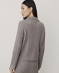 A woman wearing a taupe cable-knit sweater and matching pants stands against a plain, light-colored background. carousel Product Image 2