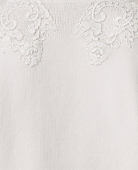 Intricate white lace floral appliqu&eacute;s adorn the neckline of a soft, cream-colored knit fabric. carousel Product Image 3