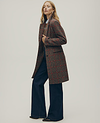A woman wearing a red and brown plaid coat and wide-leg blue jeans stands against a plain, light-colored background. carousel Product Image 3
