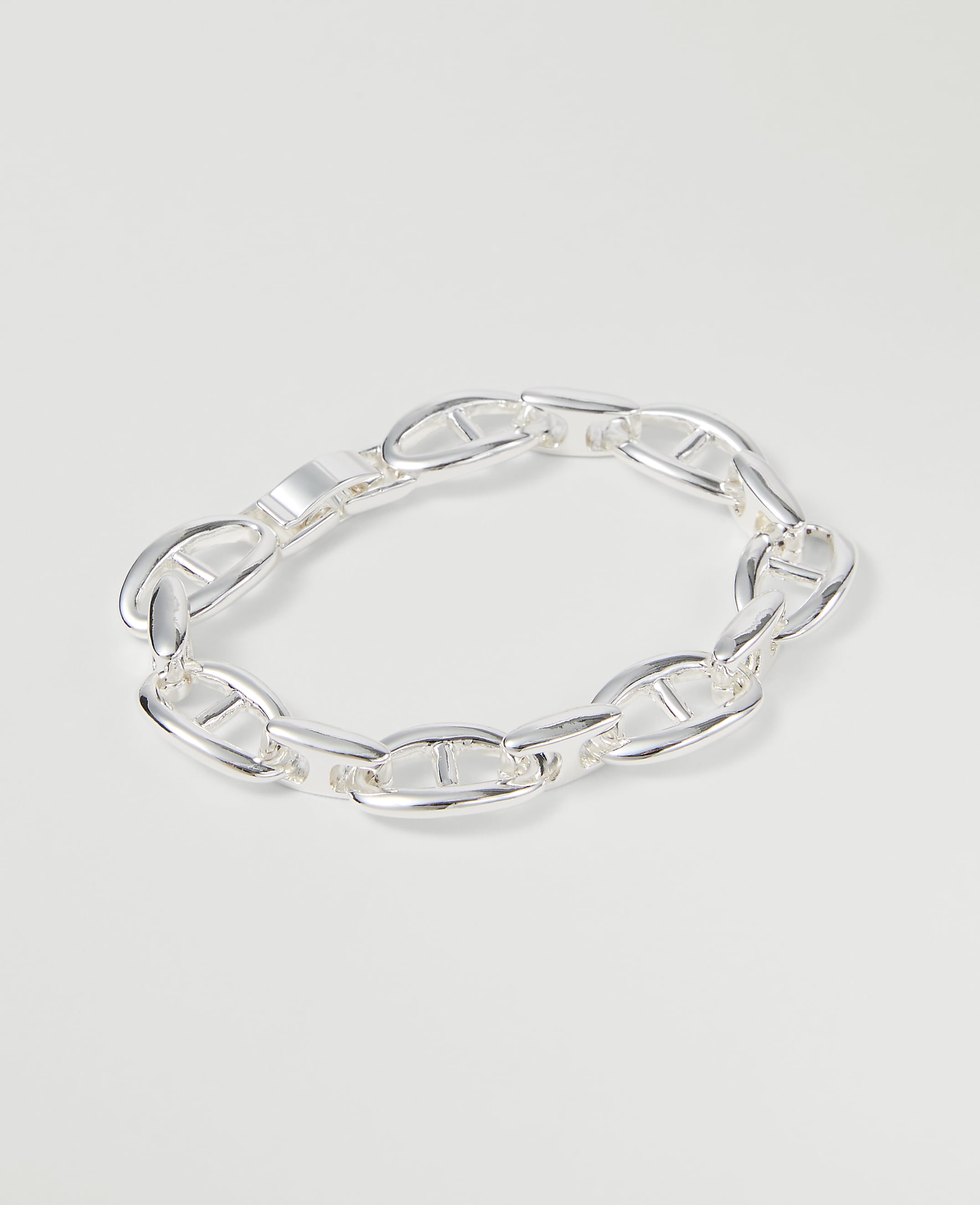 A silver anchor link bracelet rests on a plain white background.