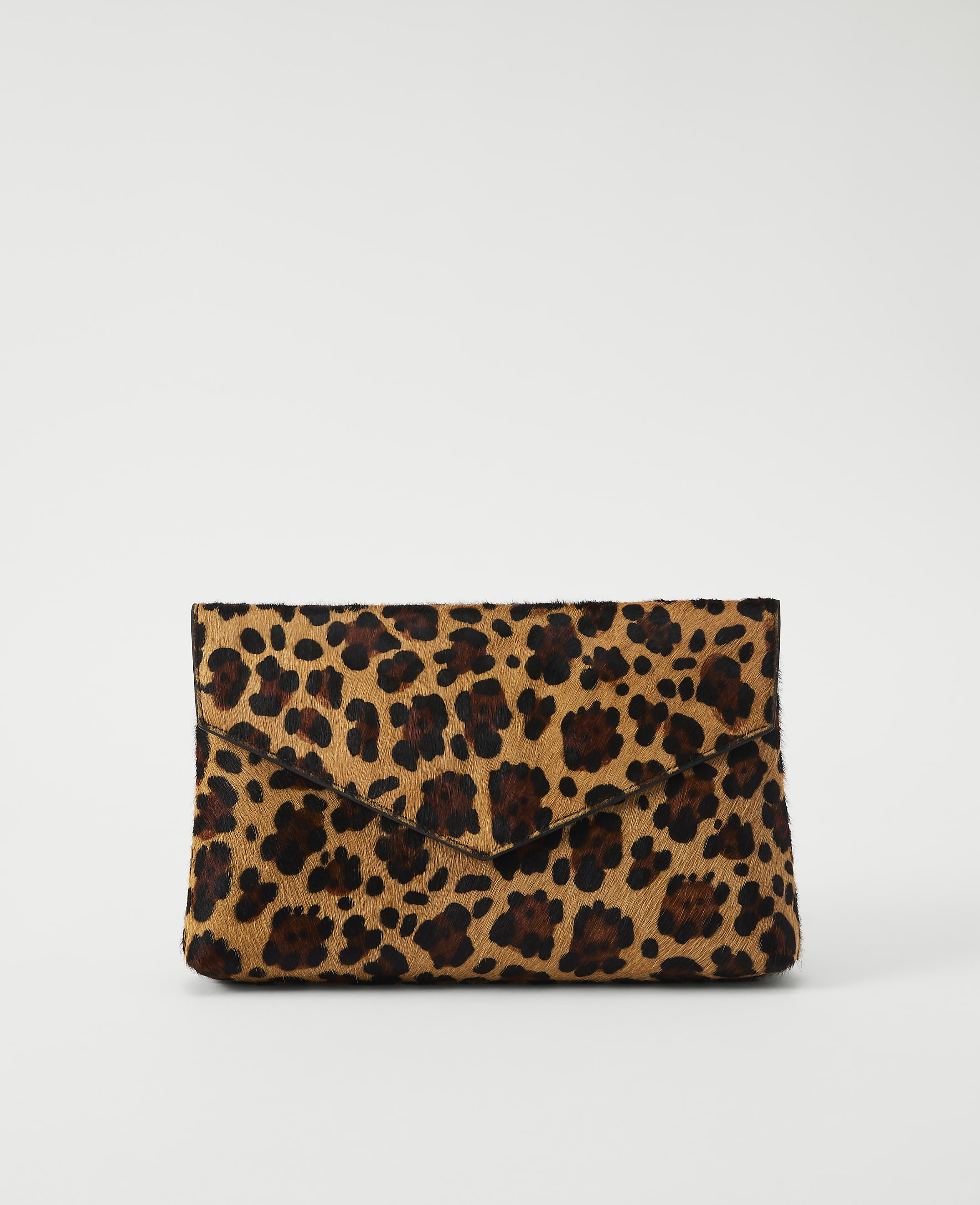 A leopard-print clutch rests on a plain white background.
