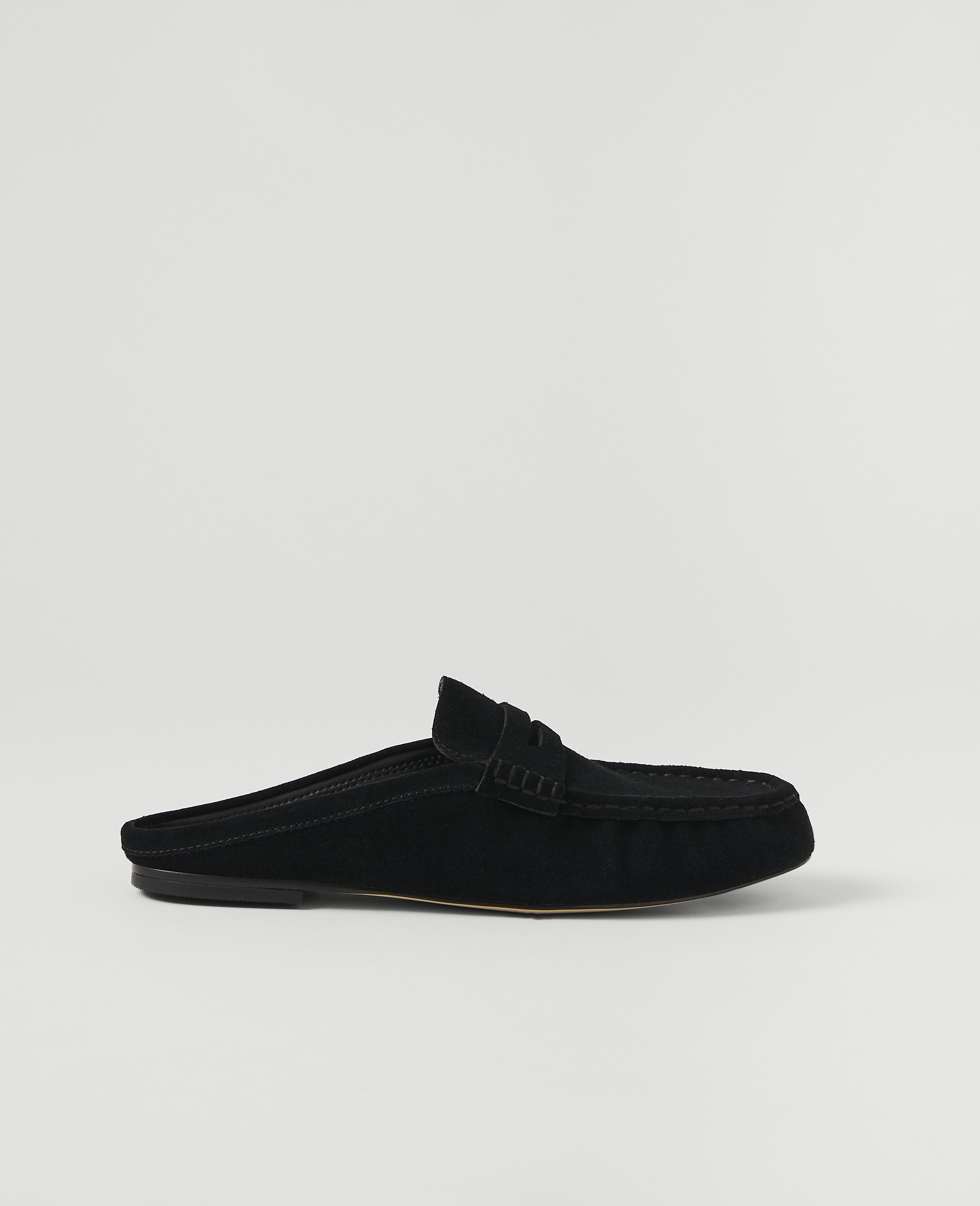 A black suede mule loafer rests on a plain white background.