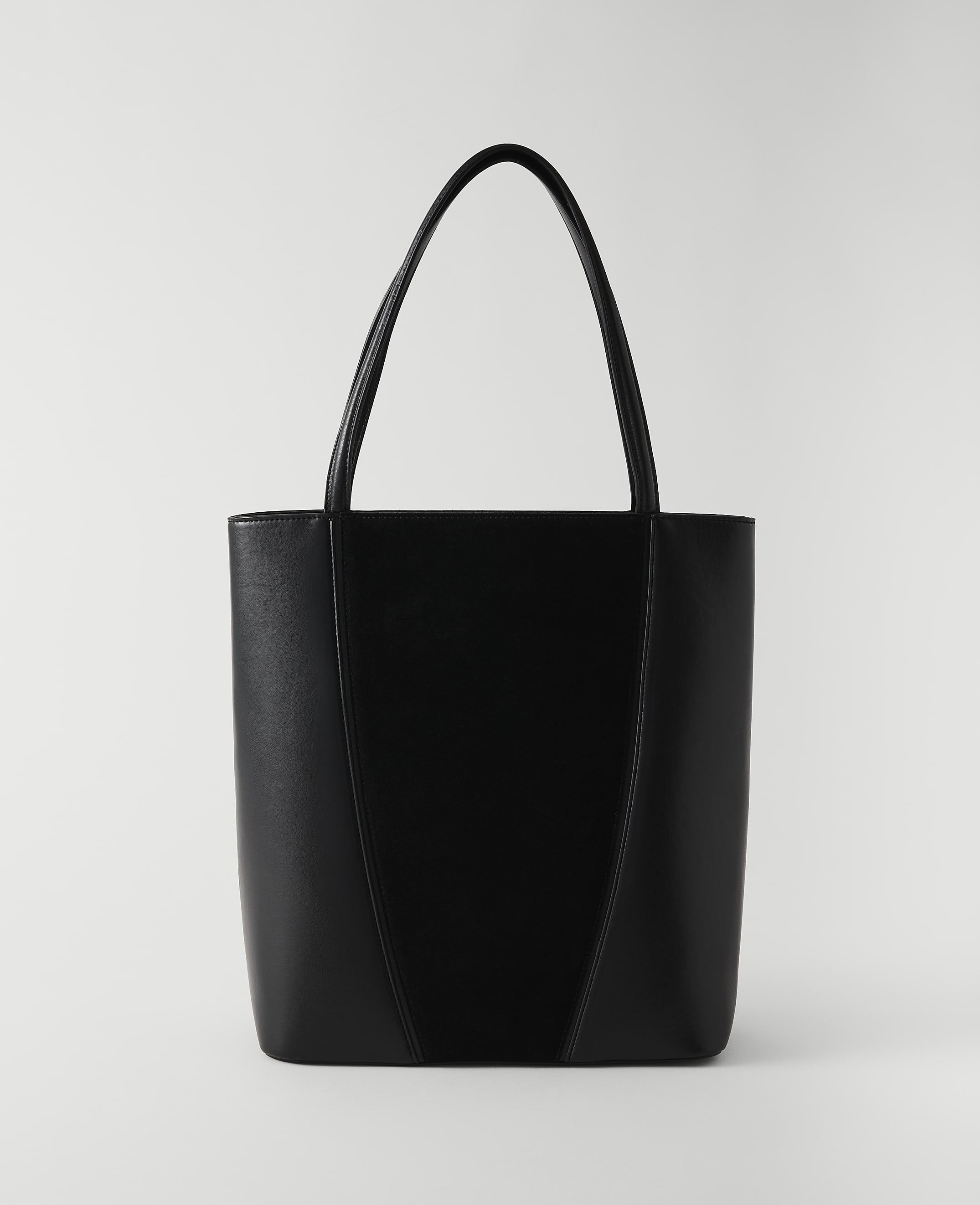 A sleek black tote bag with a V-shaped seam stands against a plain white background.