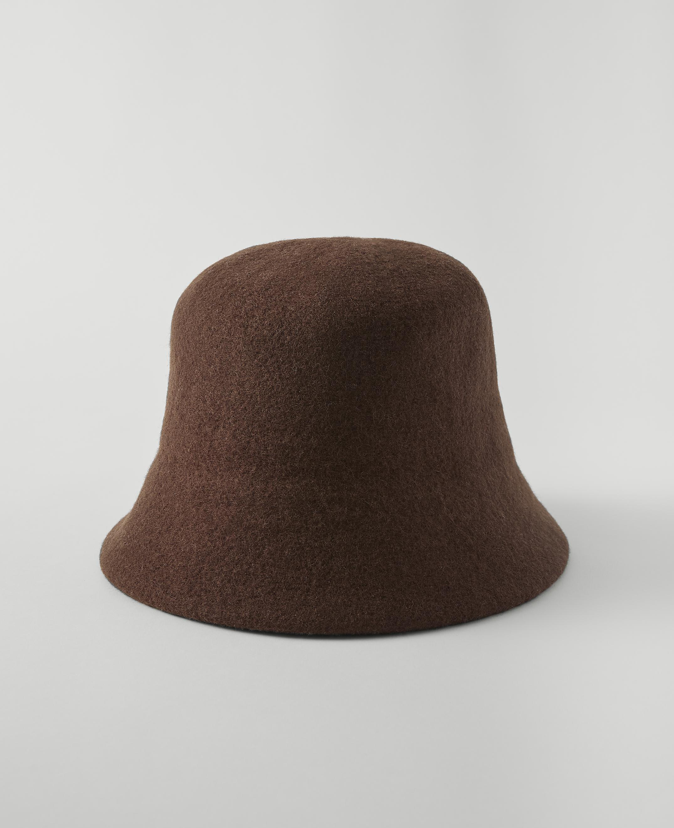 A brown felt bucket hat sits on a plain white surface against a seamless white background.