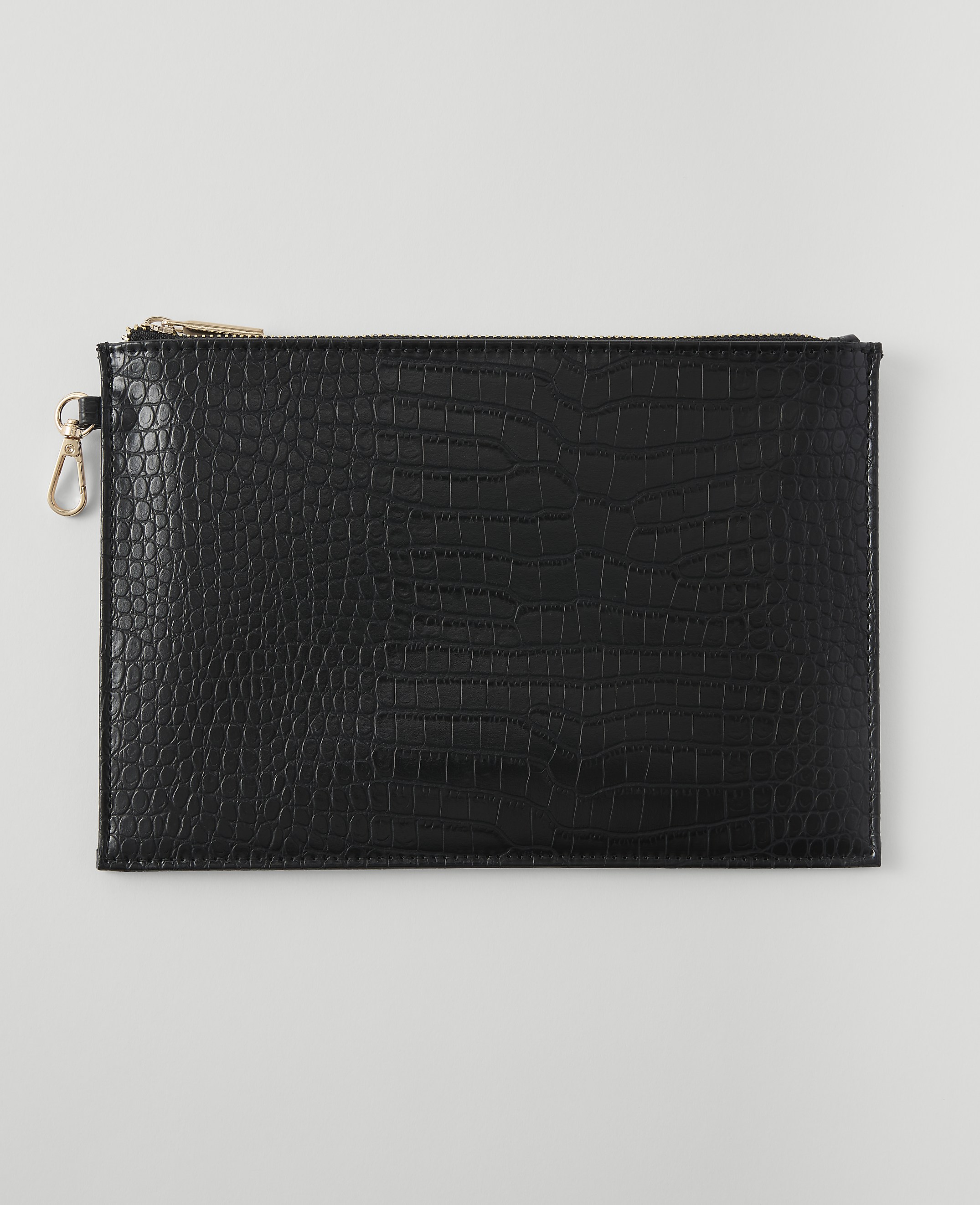 A black embossed clutch with a gold zipper and clasp rests on a plain white background.