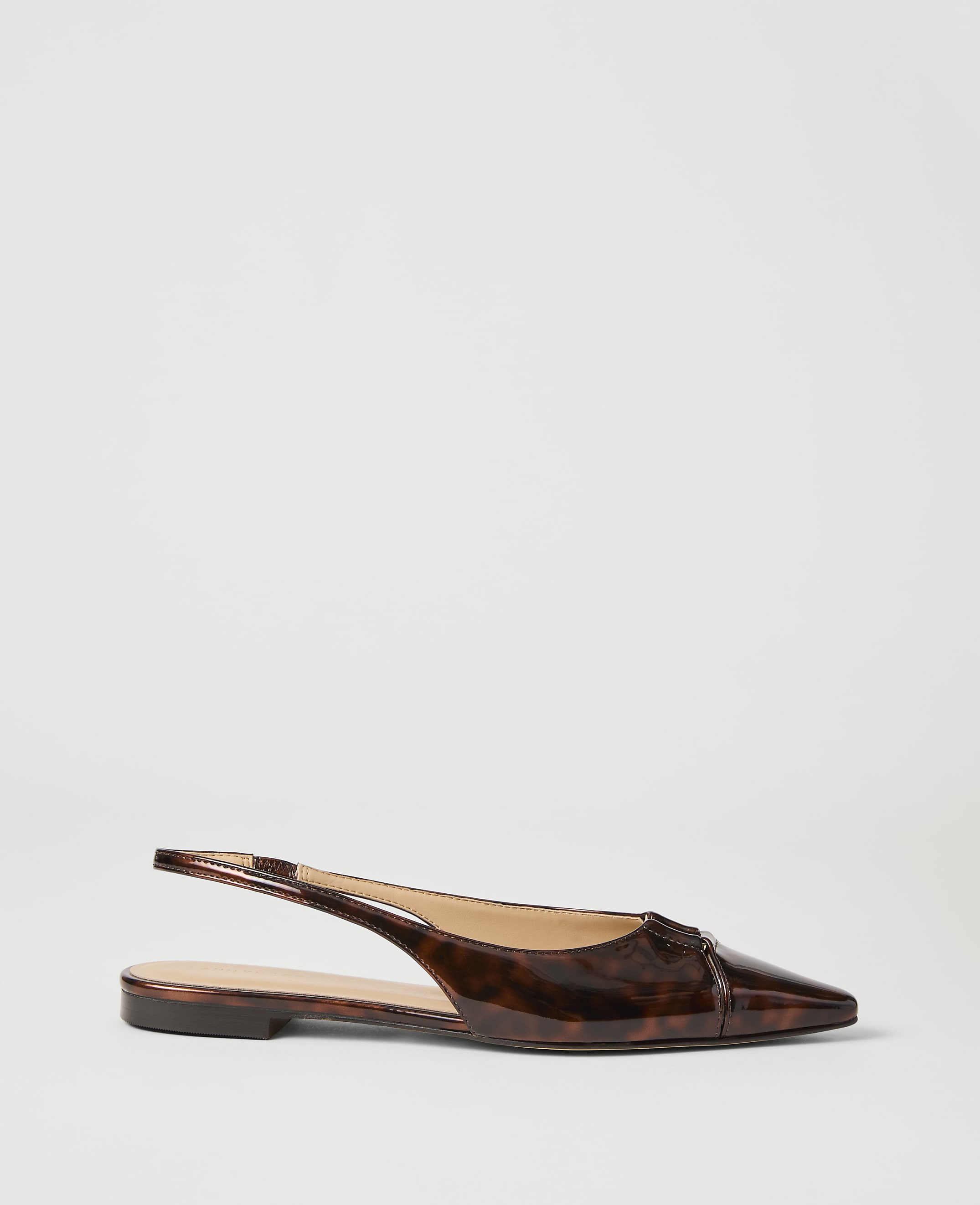 A brown tortoiseshell slingback flat shoe rests on a plain white background.