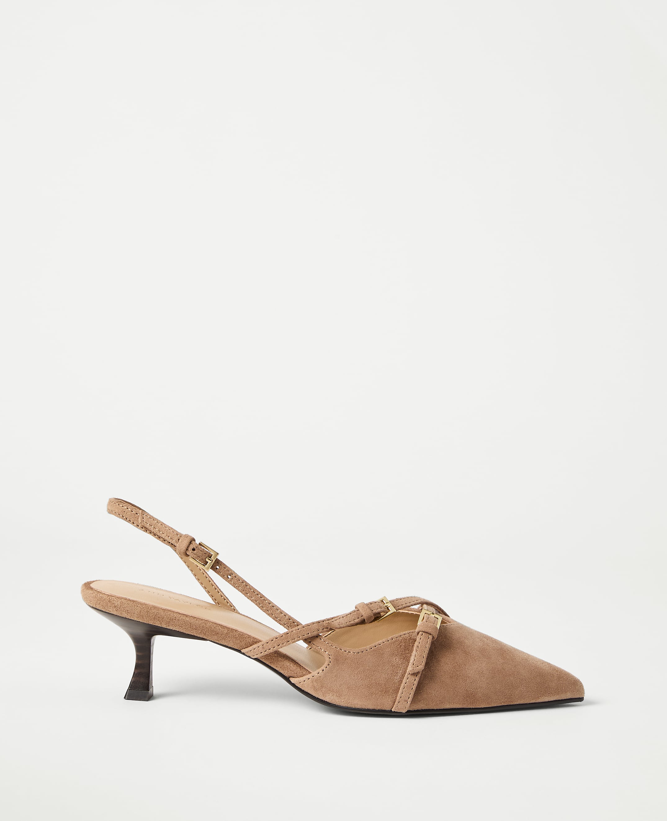 A tan suede slingback heel with delicate straps rests on a plain white background.