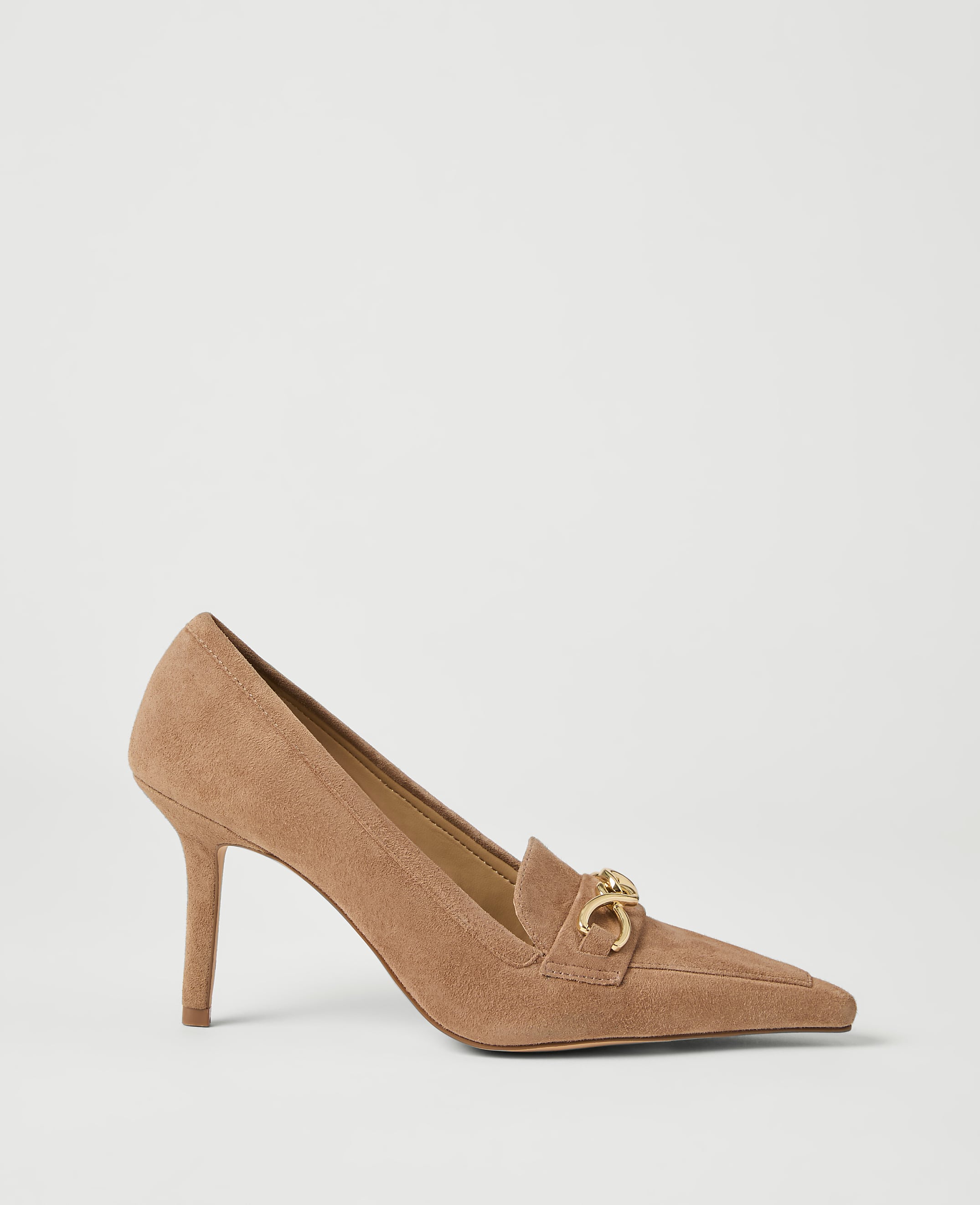 A tan suede pump with a gold horsebit detail rests on a plain white background.