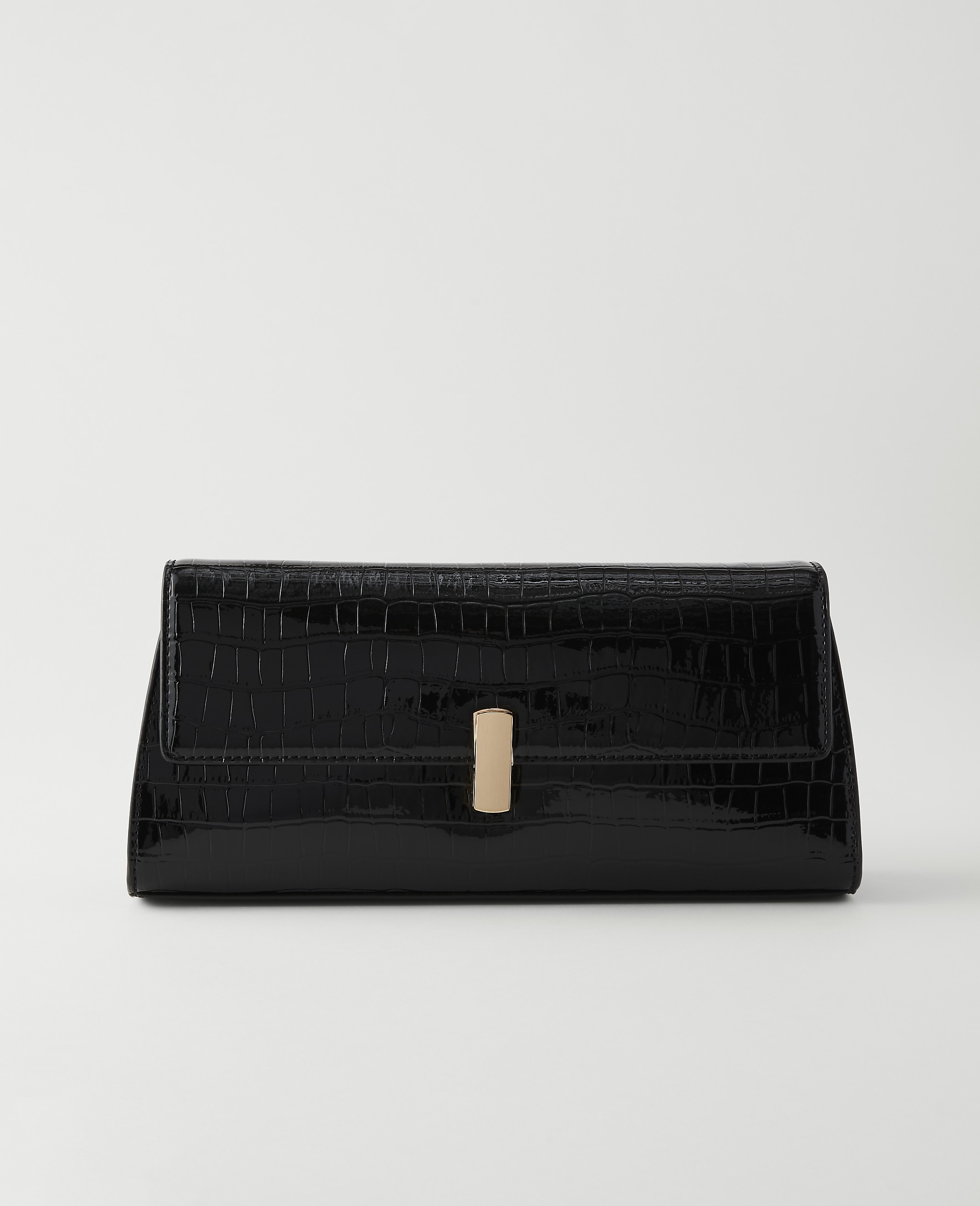 A glossy black crocodile-embossed clutch with a gold clasp rests on a plain white background.
