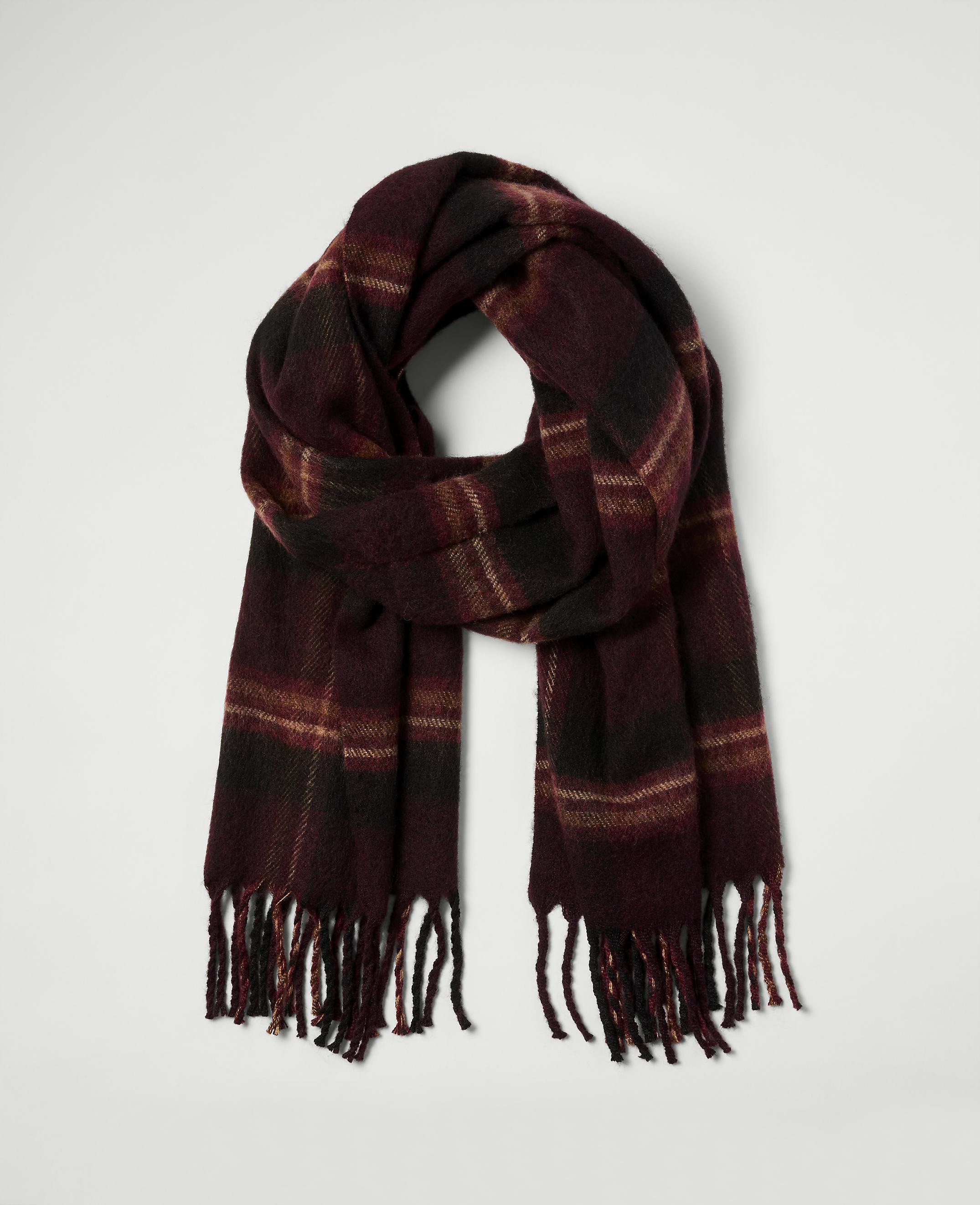 A burgundy plaid scarf with fringe hangs against a plain white background.