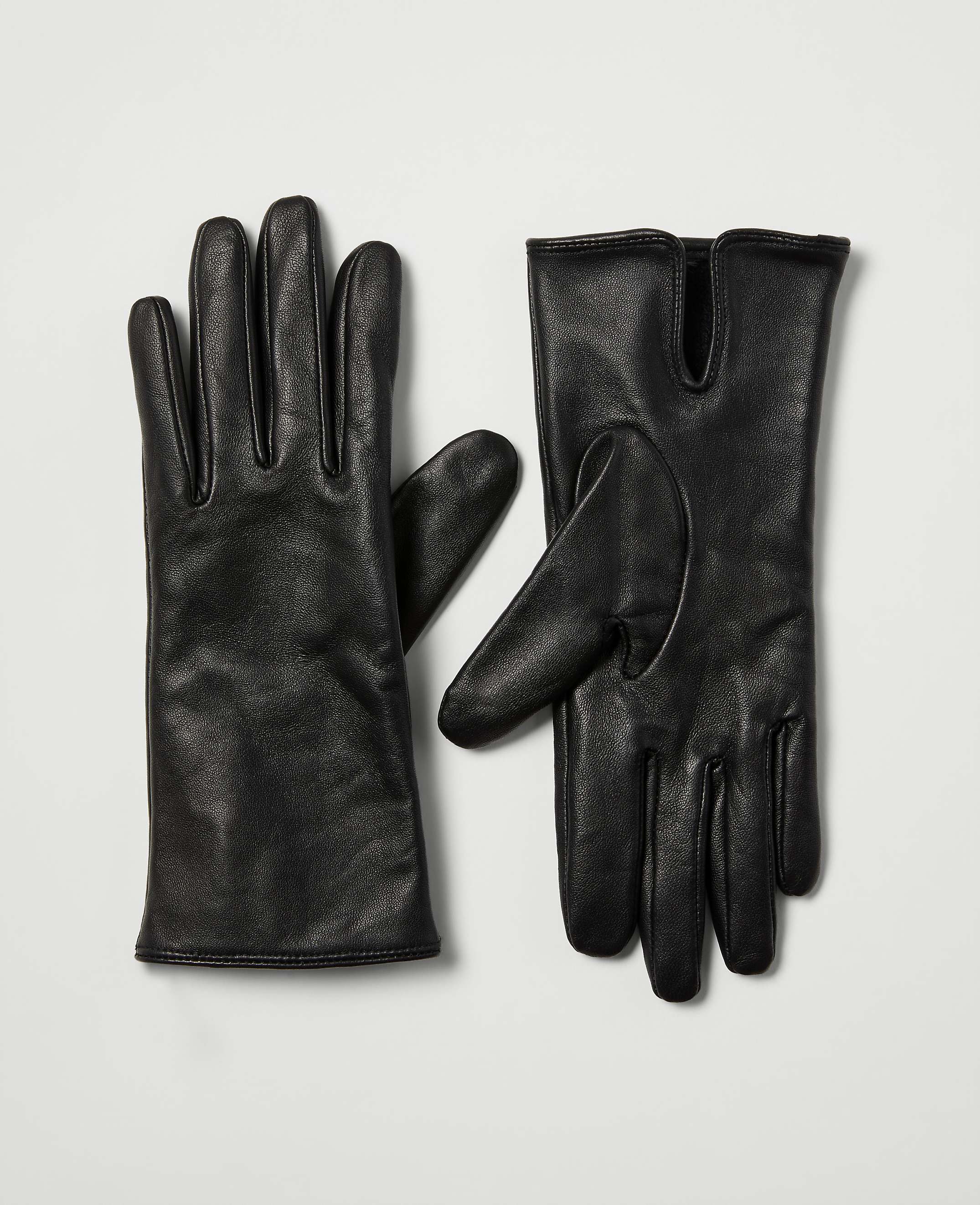 A pair of black leather gloves rests on a plain white background.