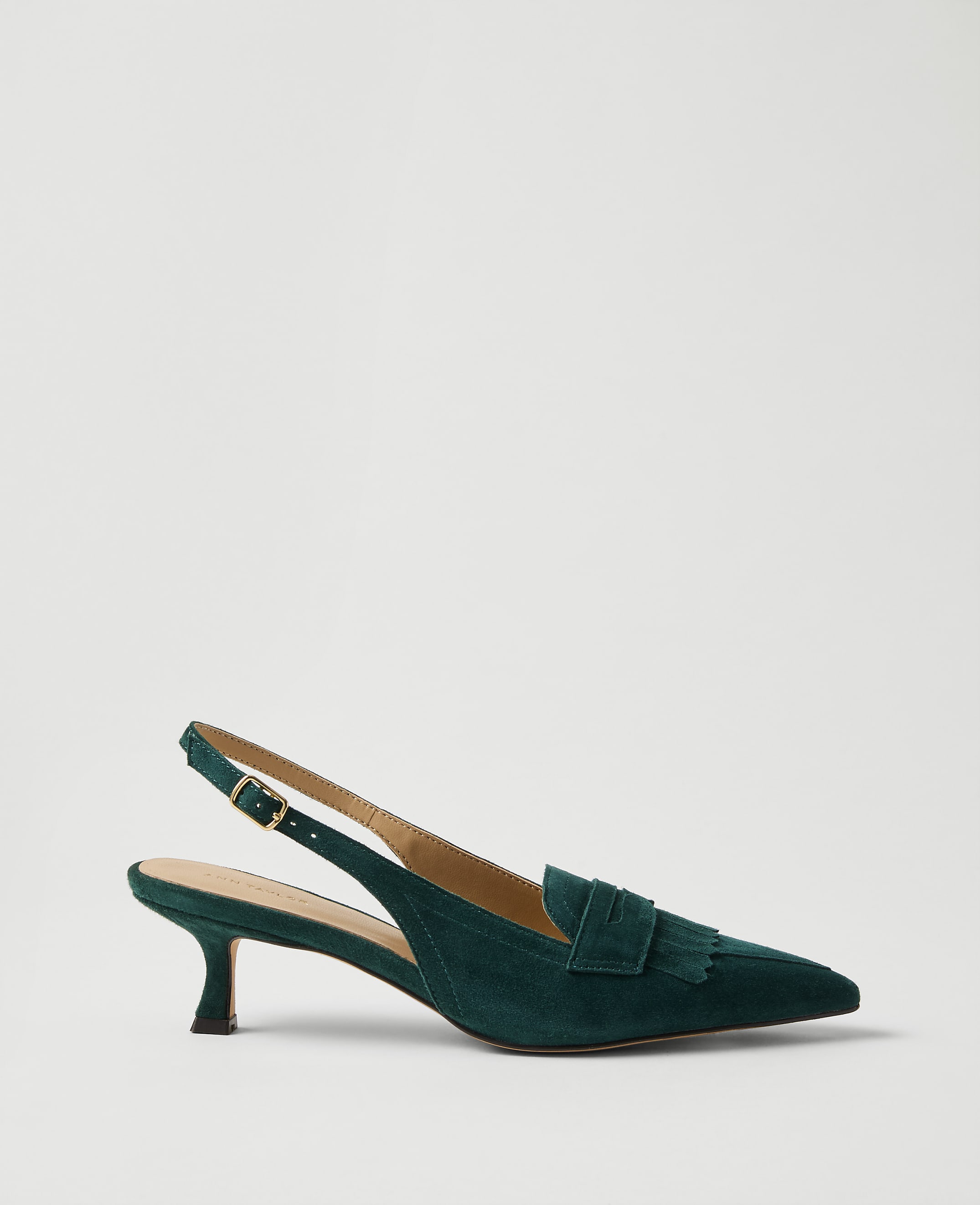 A single dark green suede slingback heel with a bow detail sits against a plain, light grey background.
