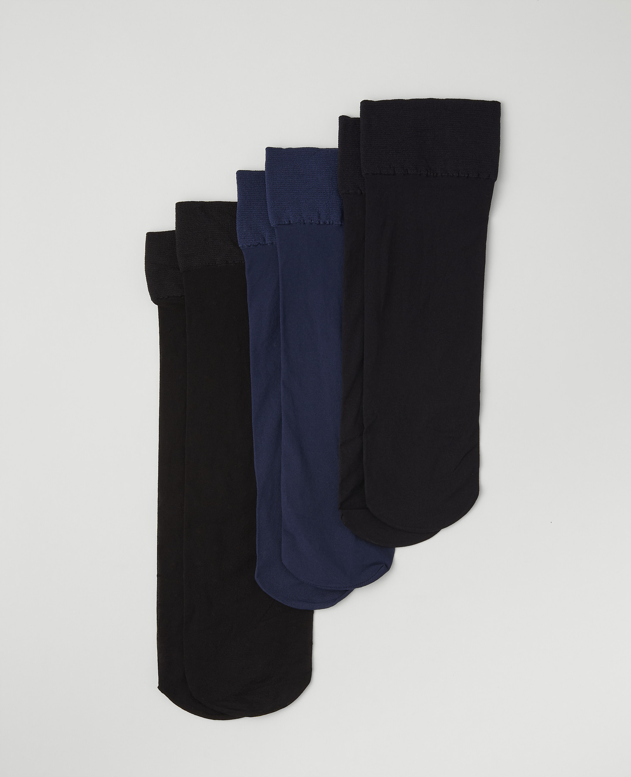 Four pairs of black and navy blue socks are arranged in a staggered row against a plain light gray background.