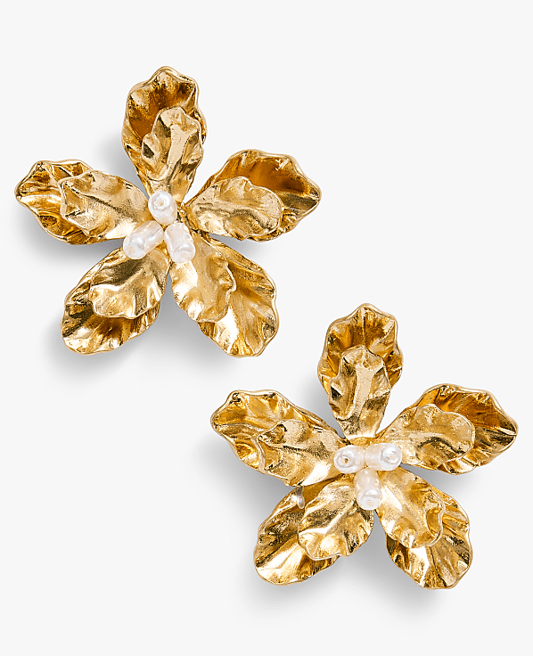 The image depicts two golden, flower-shaped objects with intricate, petal-like structures against a plain white background.