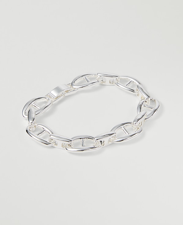 A silver anchor link bracelet rests on a plain white background.