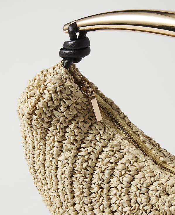 A woven straw clutch with a gold zipper and a curved gold handle is set against a plain white background.