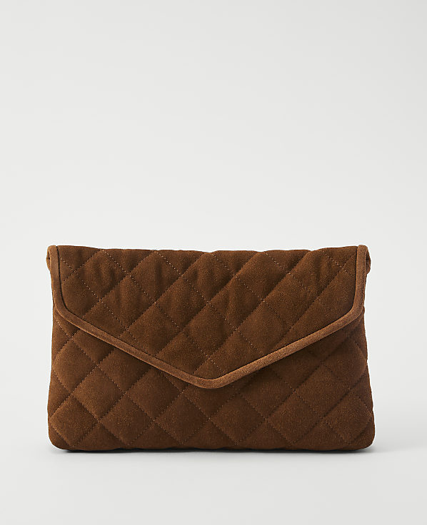 A brown quilted clutch with a flap closure rests against a plain white background.