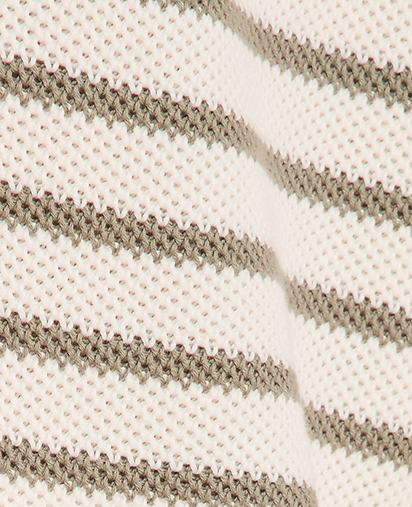 A close-up view of a cream-colored knitted fabric with horizontal grey stripes fills the frame, with a subtle fold creating a soft shadow in the background.