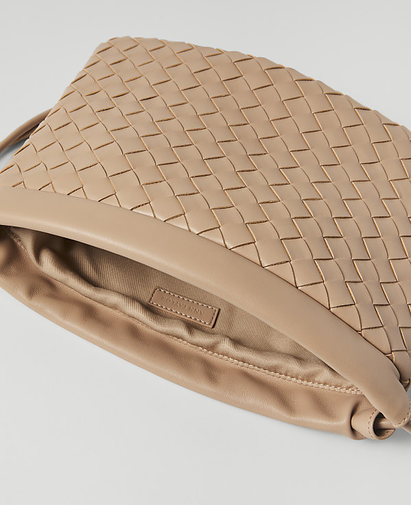 A woven beige leather clutch bag with a smooth leather trim is displayed against a plain white background.