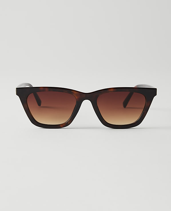 Tortoiseshell sunglasses with gradient brown lenses are centered against a plain white background.