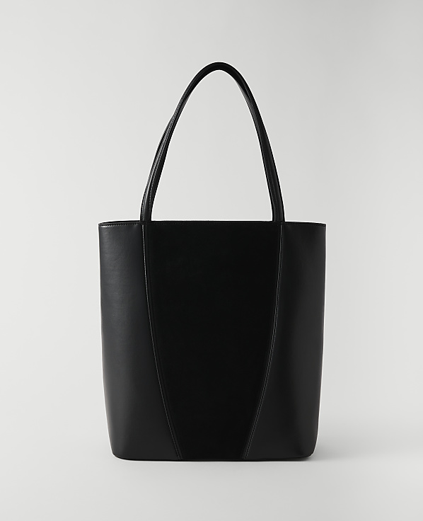 A sleek black tote bag with a V-shaped seam stands against a plain white background.