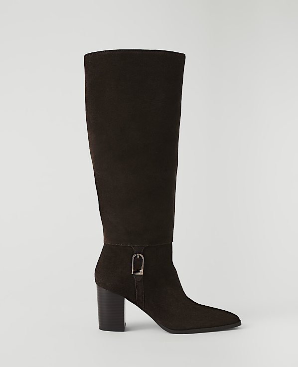 A dark brown suede knee-high boot with a buckle detail stands on a plain white background.