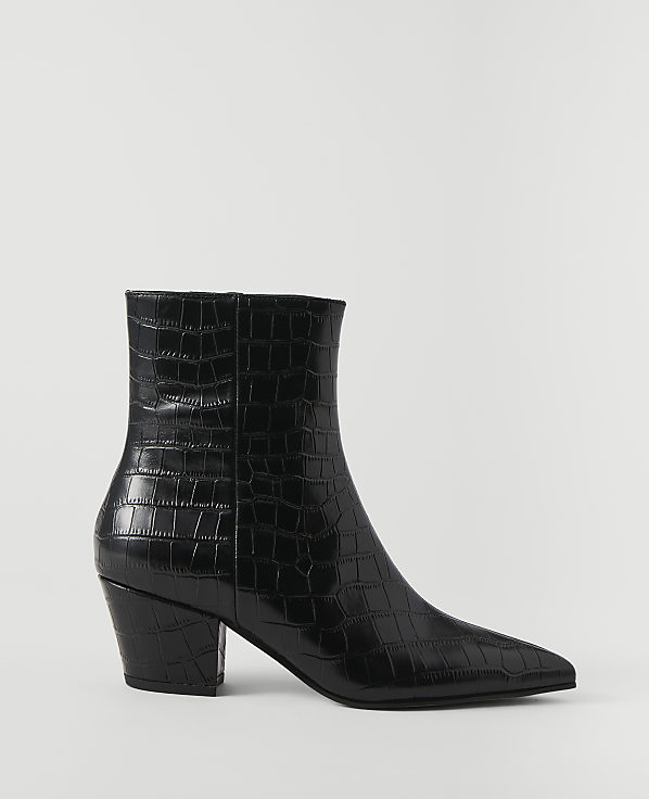 A black, crocodile-embossed ankle boot with a pointed toe and block heel stands against a plain white background.
