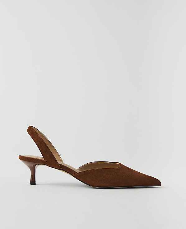 A brown suede slingback heel with a pointed toe rests on a plain white background.