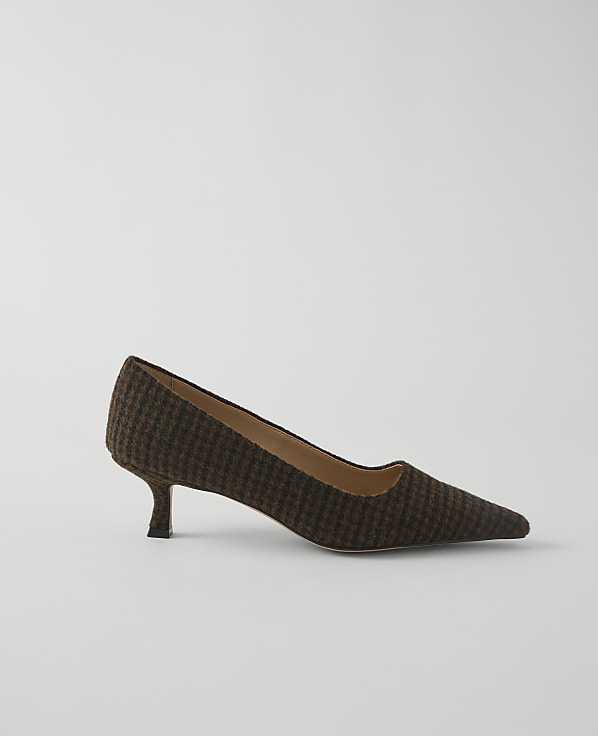 A brown and black patterned pump with a pointed toe and kitten heel rests on a plain white background.