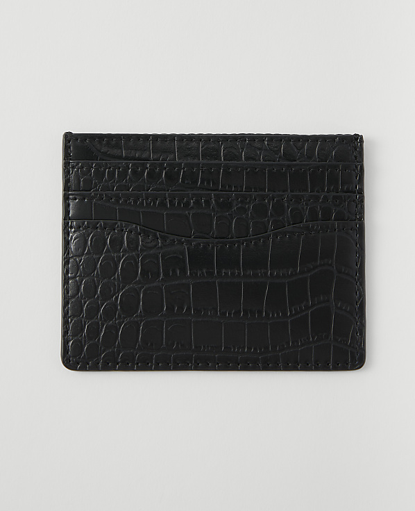 A black crocodile-embossed cardholder with multiple slots rests on a plain white background.