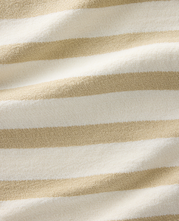 A close-up view of a textured fabric with alternating horizontal stripes of cream and tan fills the frame.