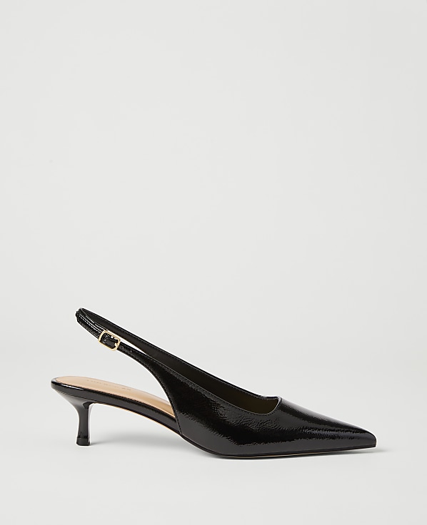 A black patent leather slingback heel with a pointed toe rests on a plain white background.
