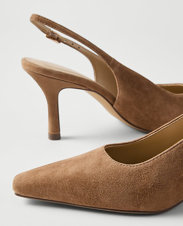 A pair of tan suede slingback heels with a square toe are in the foreground, with a plain white background.