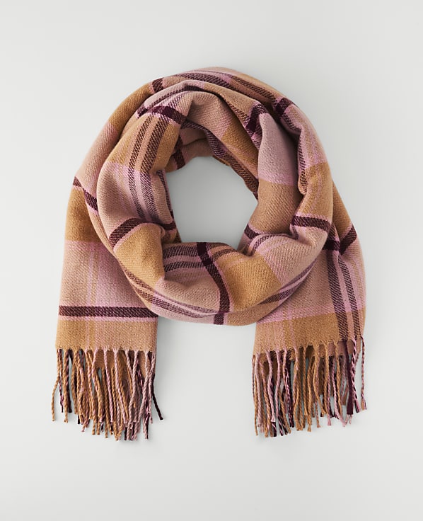 A plaid scarf with fringed ends lies on a plain white background.
