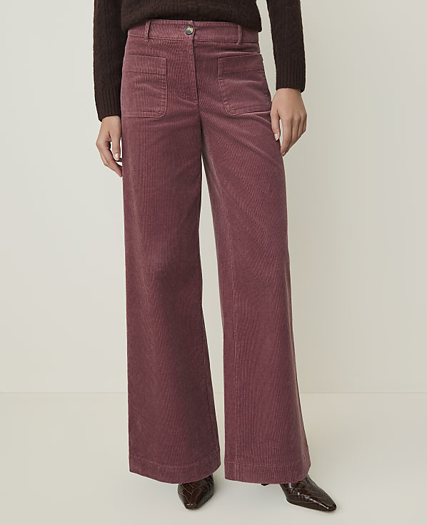 A person wearing wide-leg corduroy pants stands against a plain, light-colored background.